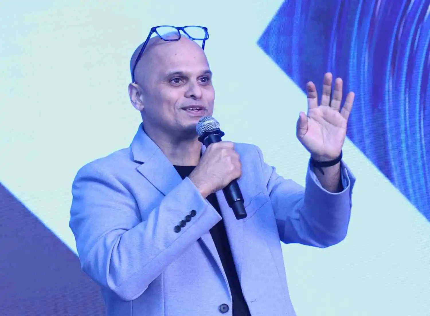 Vikram Sathaye moderating a panel discussion at a corporate event in Mumbai.