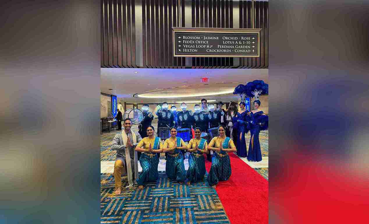 A marching band and a dance group performing at a corporate event in Las Vegas