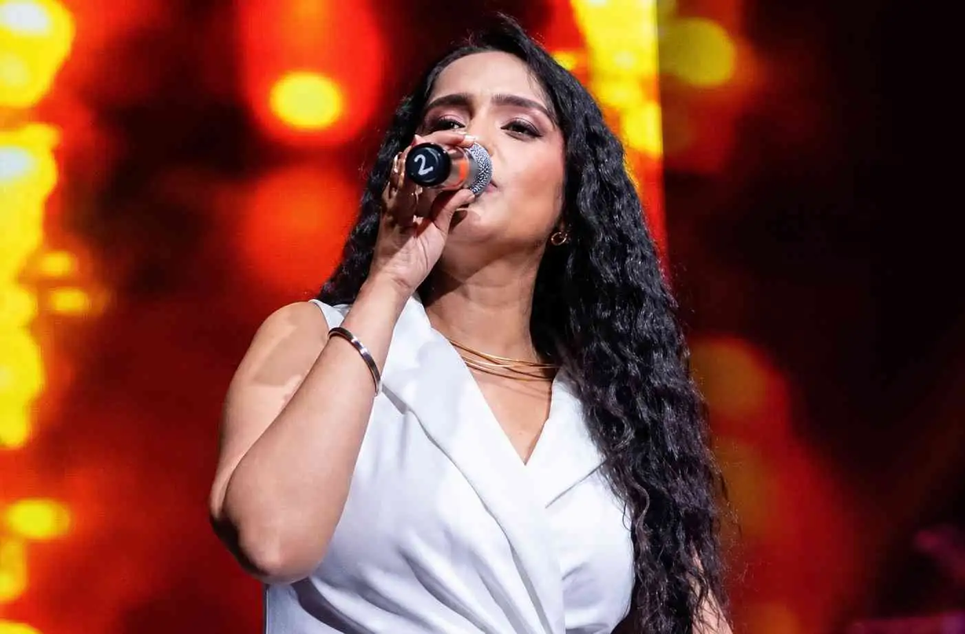 Singer Asees Kaur performing at a corporate event in Delhi
