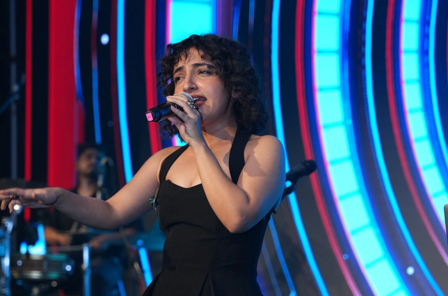Singer Poorvi Koutish performing at a corporate event in Hong Kong